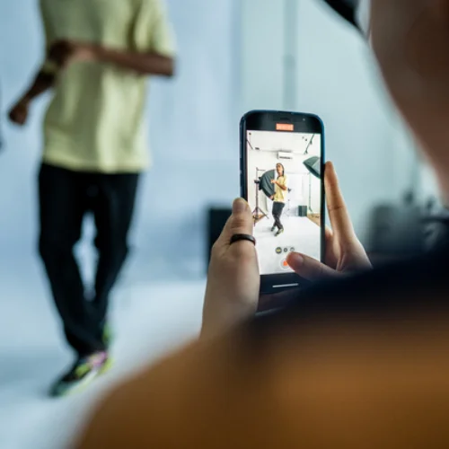 Person using smartphone to film a photoshoot; Marketing Agency Ireland